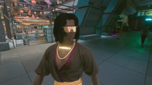 Gelockter Mann mit viel Gold- und leuchtendem Schmuck. Screenshot aus dem Spiel Cyberpunk 2077 im Blog von Nastja der Mox. The Nameless of Night City ist eine Würdigung an die Ingame-NPCs.