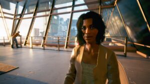 Frau in einer fast leeren Halle mit der Skyline im Hintergrund. Screenshot aus dem Spiel Cyberpunk 2077 im Blog von Nastja der Mox. The Nameless of Night City ist eine Würdigung an die Ingame-NPCs.