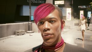 Nahgesichtsaufname eine jungen Mannes in Night City. Screenshot aus dem Spiel Cyberpunk 2077