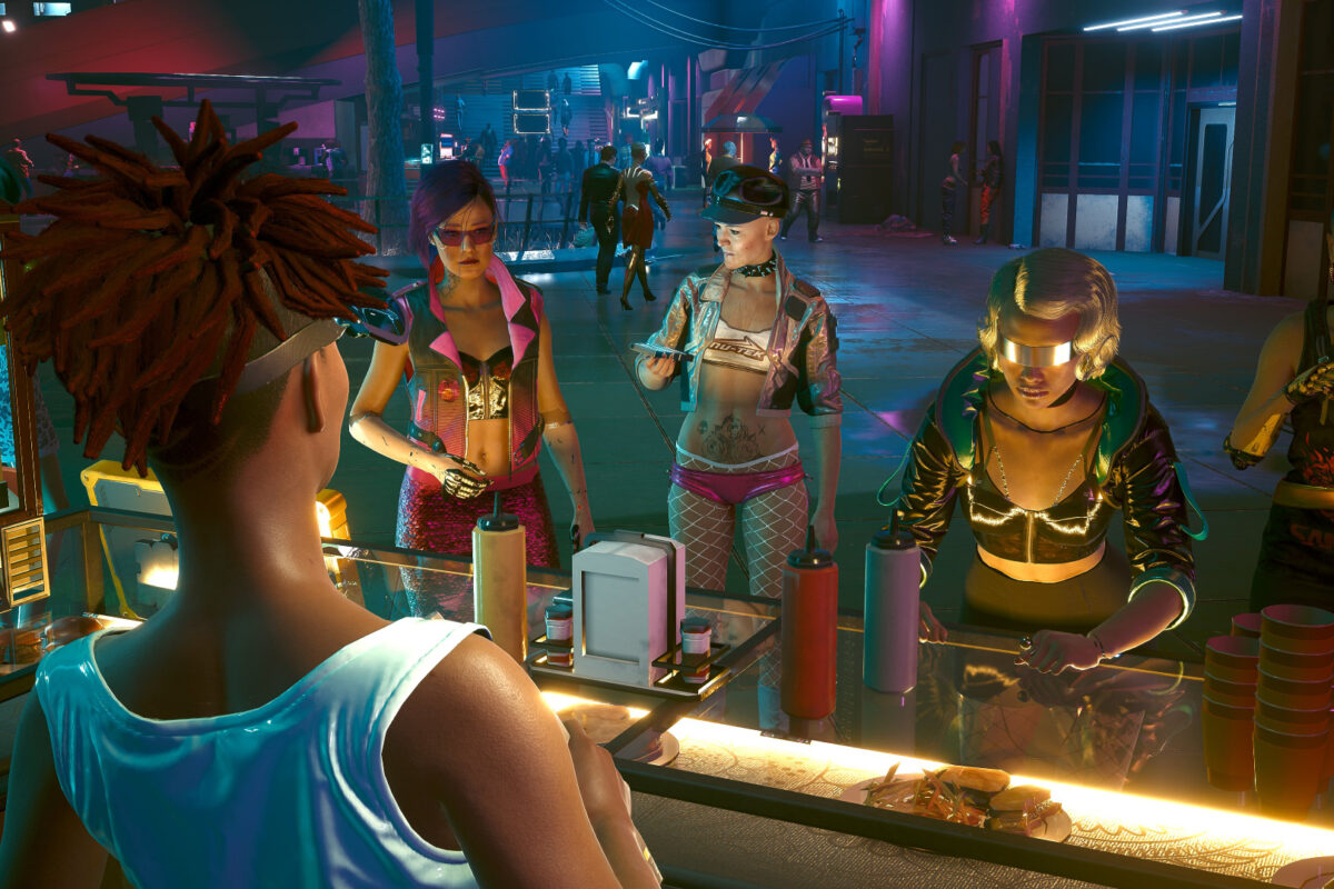 4 Frauen aus Night City,stehen an einem fast Food Stand an. Screenshot aus dem Spiel Cyberpunk 2077.