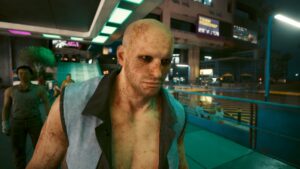 Glatzköpfiger, schmutziger heruntergekommener Mann im Porträt. Screenshot aus dem Spiel Cyberpunk 2077